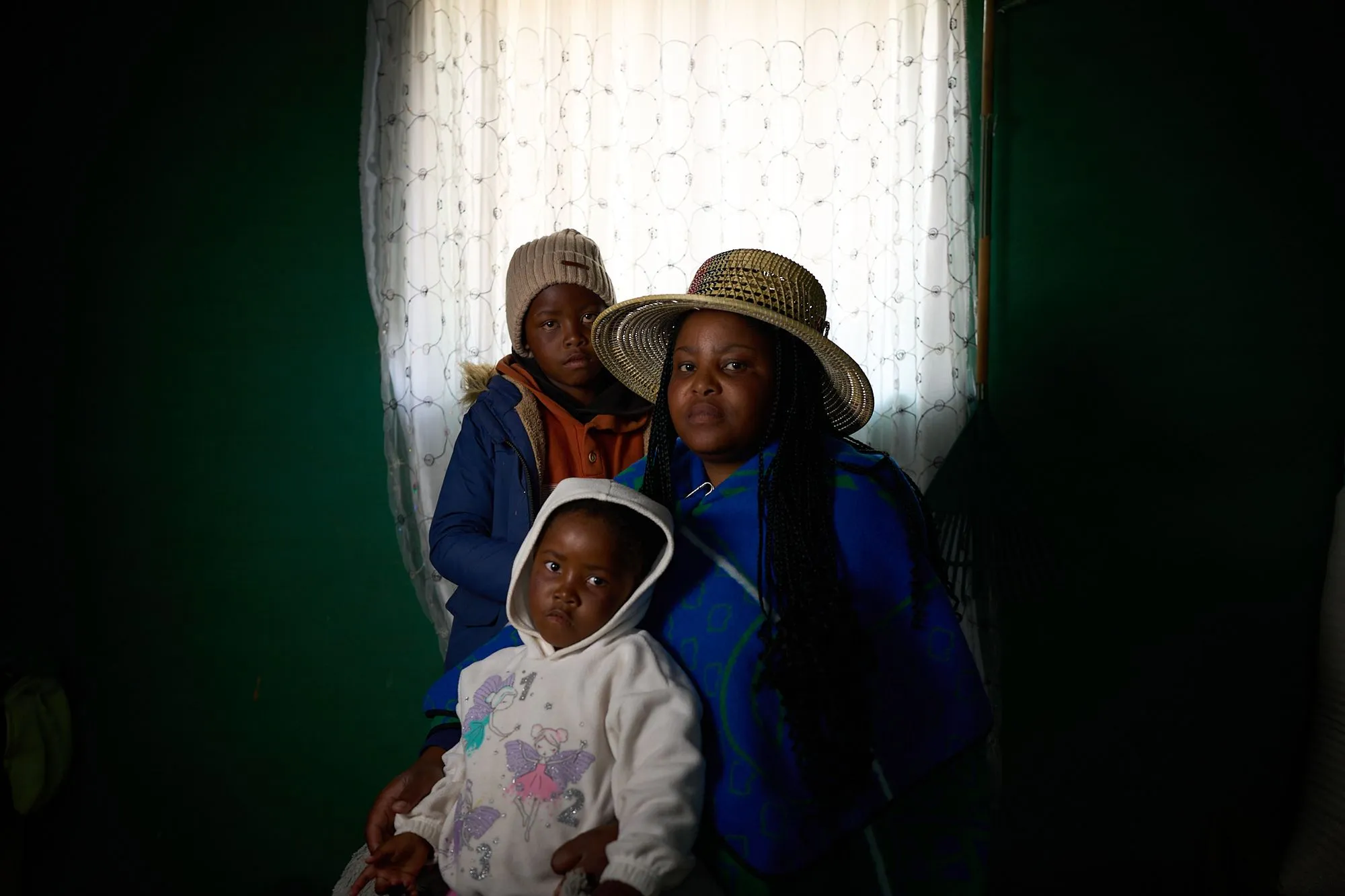 Matseliso Lekhoele and 2 children posing for a portrait