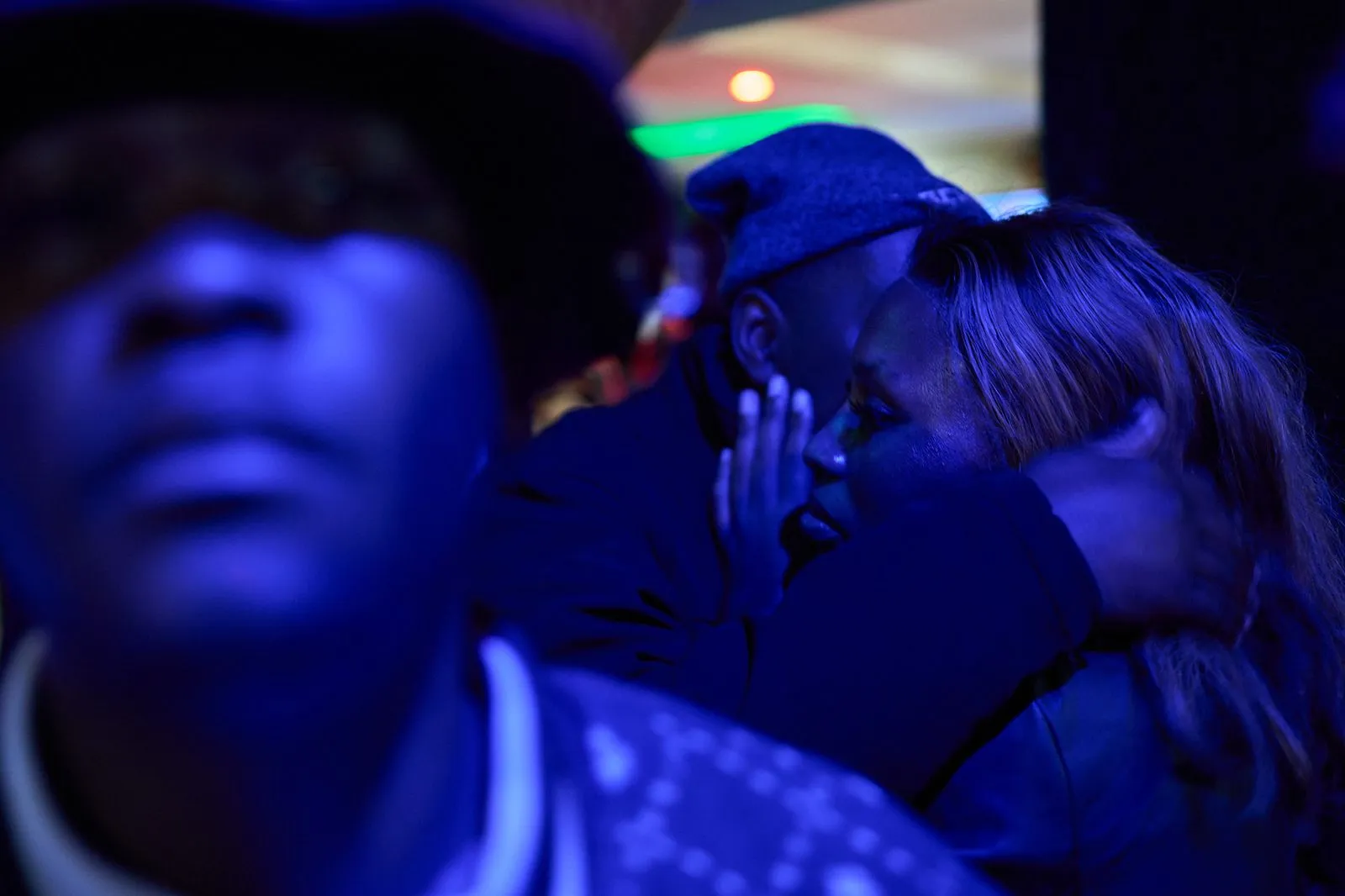 A man embracing a woman inside a club