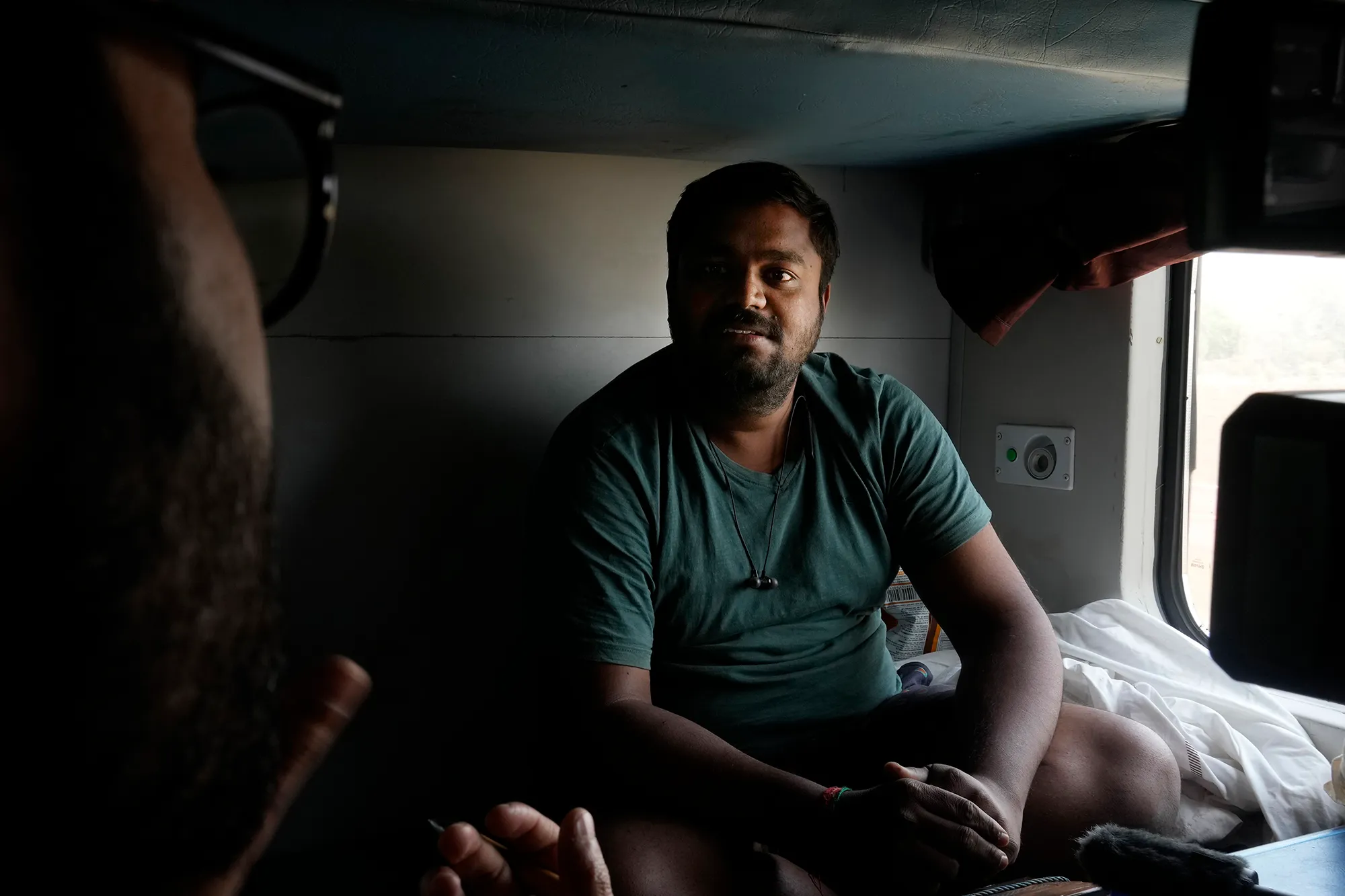 An Indian man sitting in a train