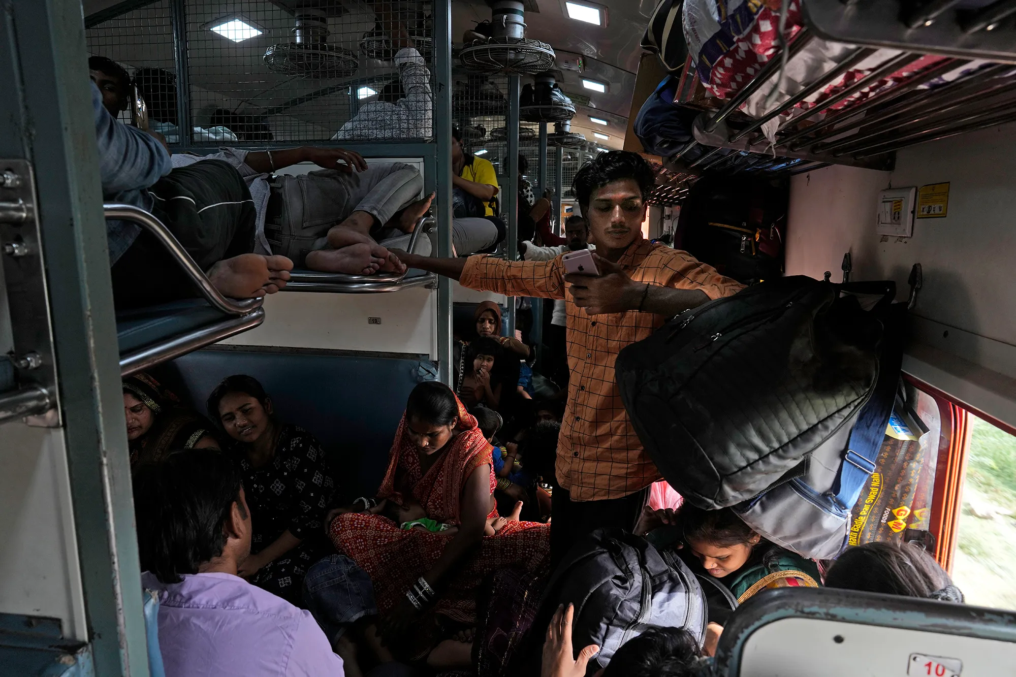 A group of people in an Indian train carriage.