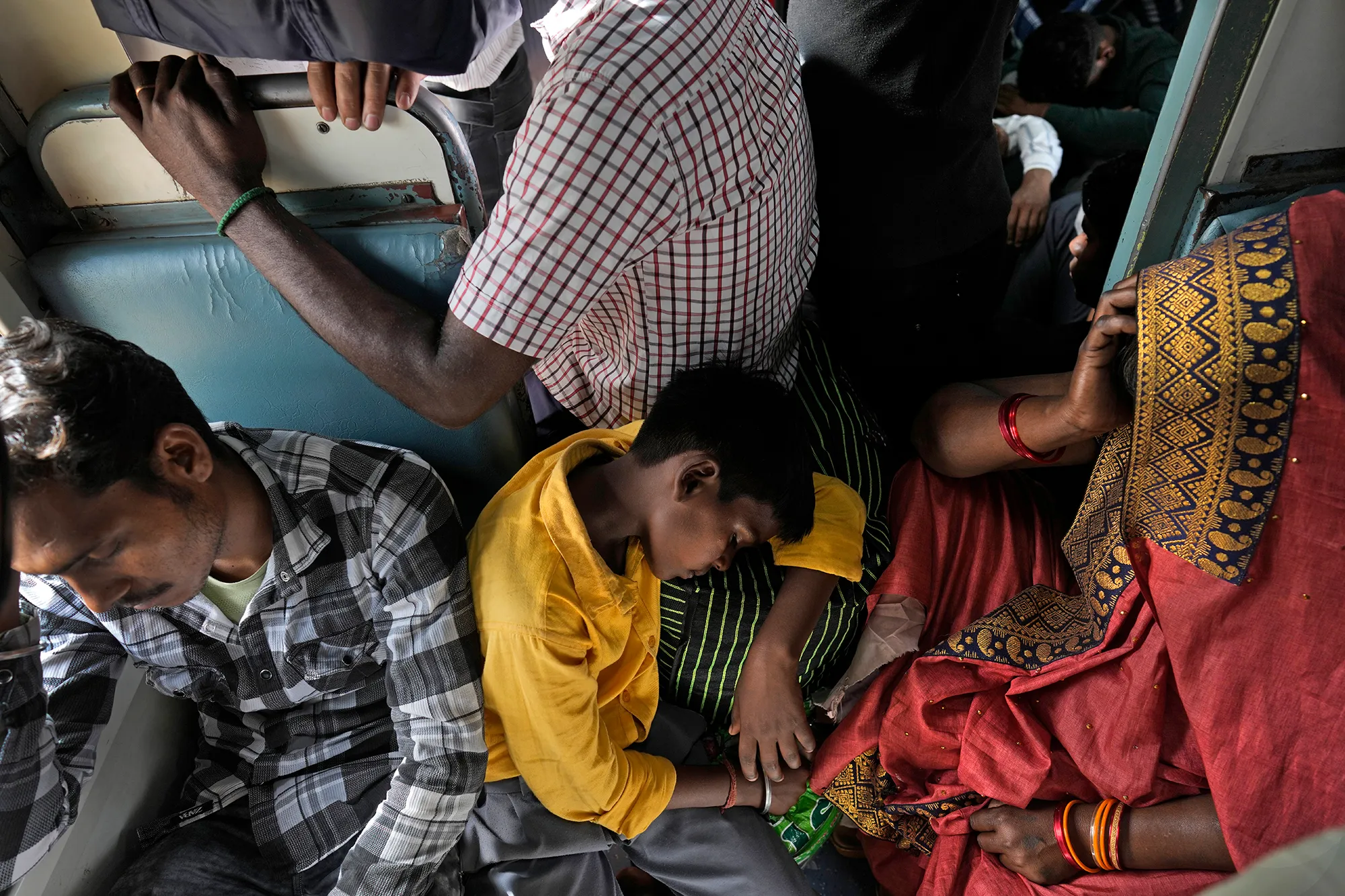 A group of people in an Indian train carriage.