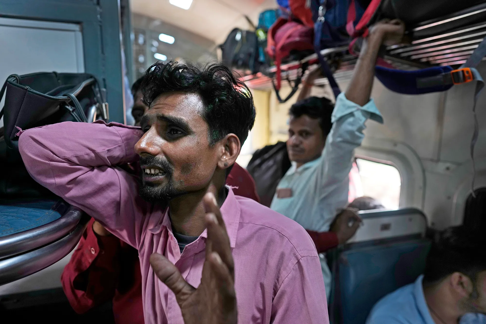 A group of people in an Indian train carriage.