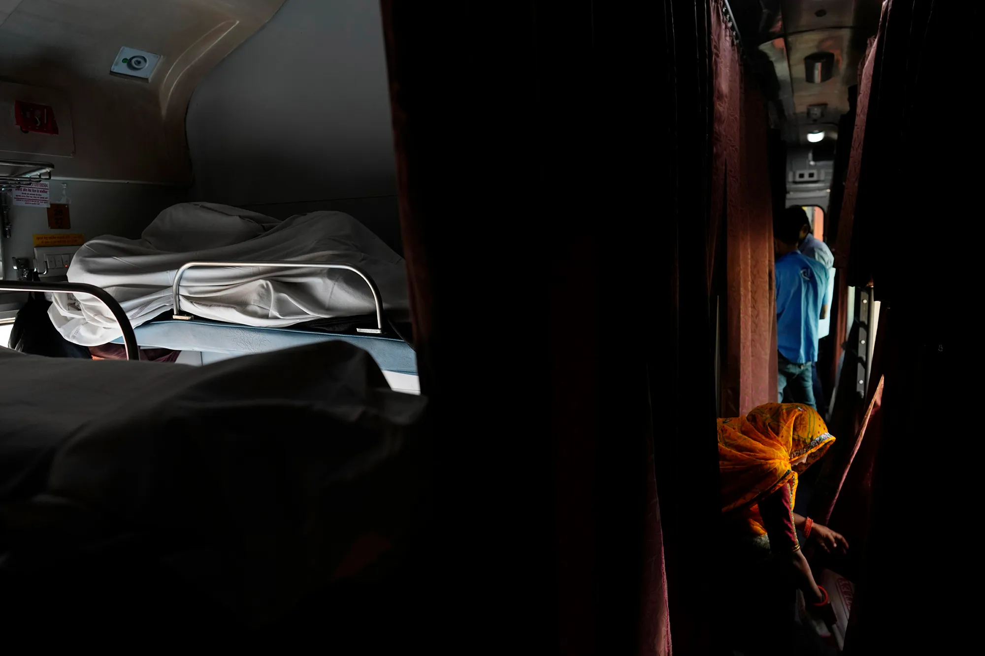 A group of people in an Indian train carriage.