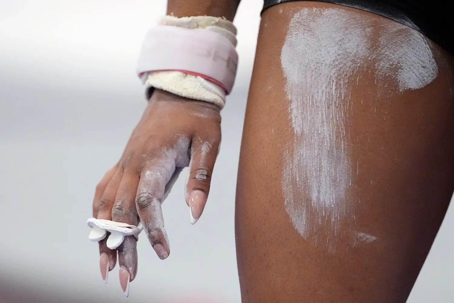 Close up of gymnasts hand covered in powder