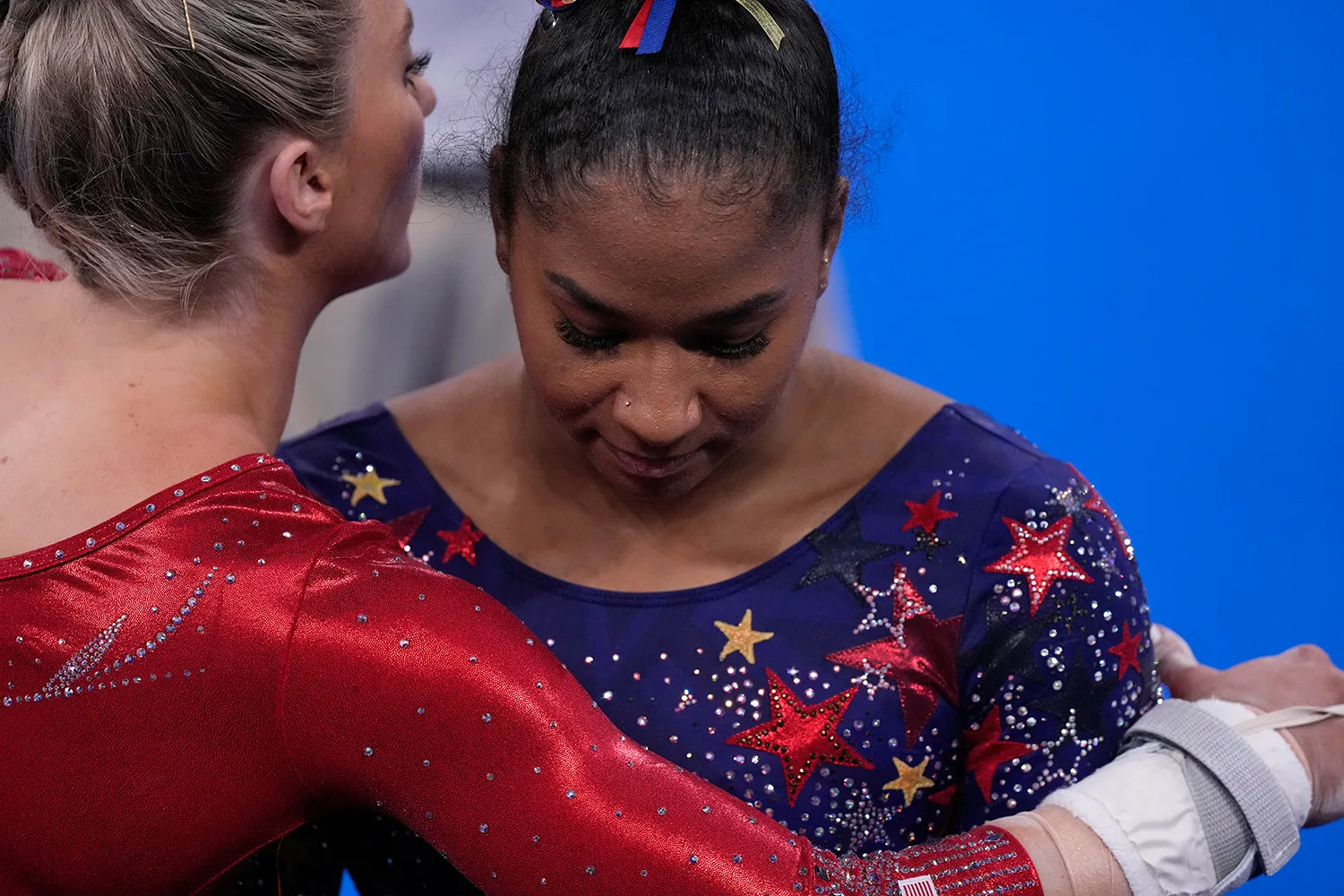 Gymnast Jordan Chiles being hugged by a team mate.