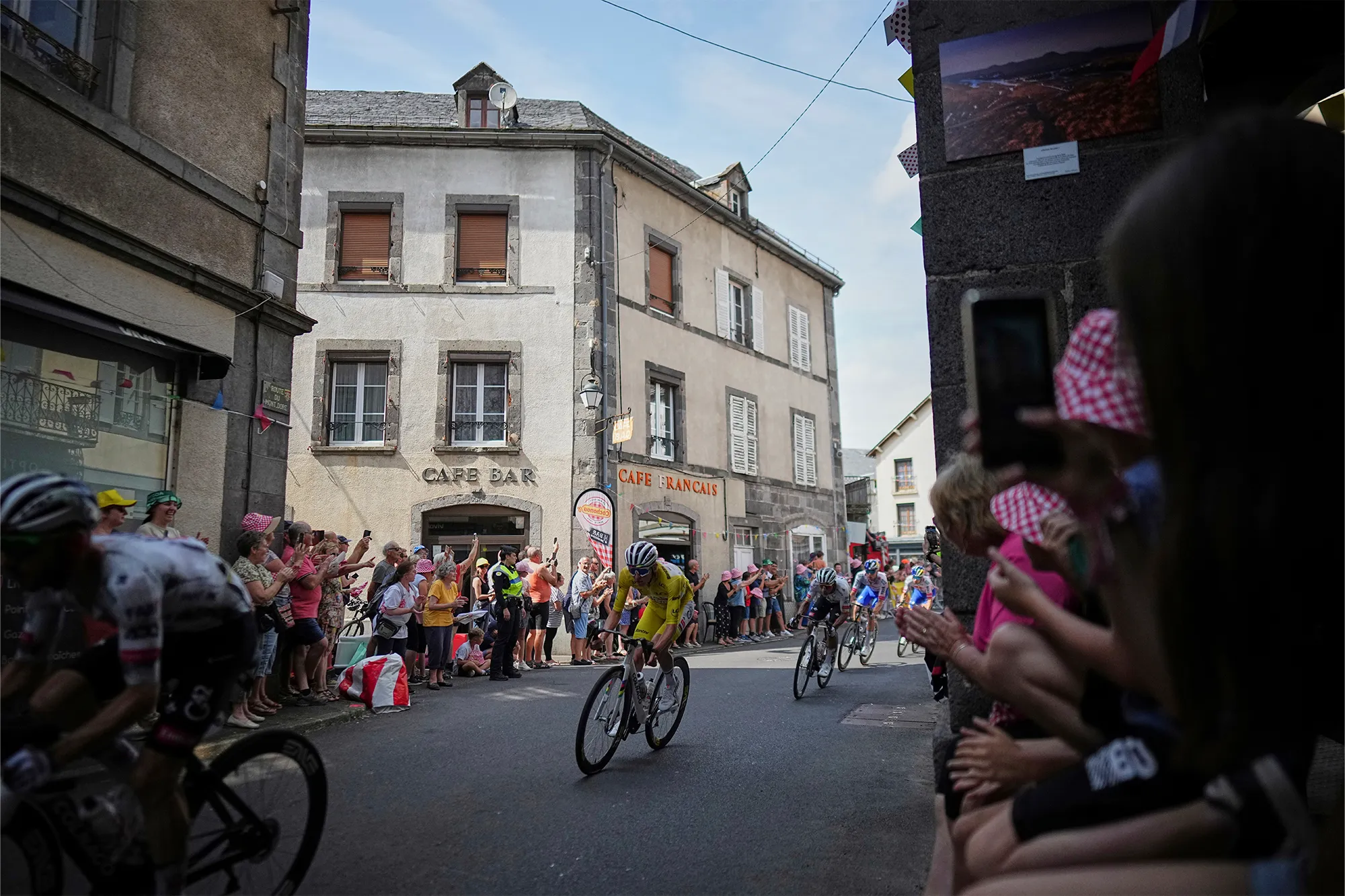 Slovenia's Tadej Pogacar, wearing the overall leader's yellow jersey, rides in the pack