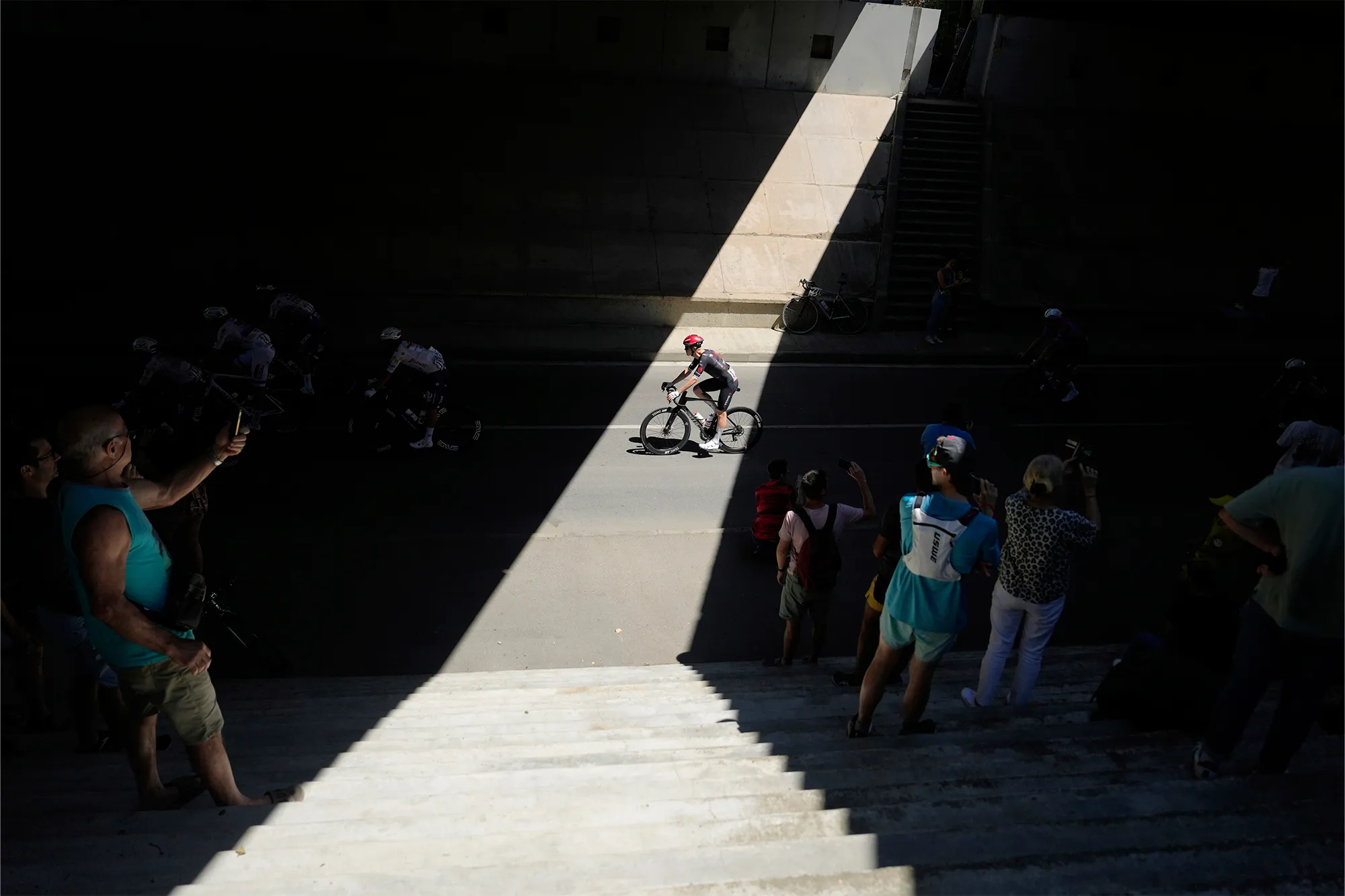 Spectators taking photos of cyclists