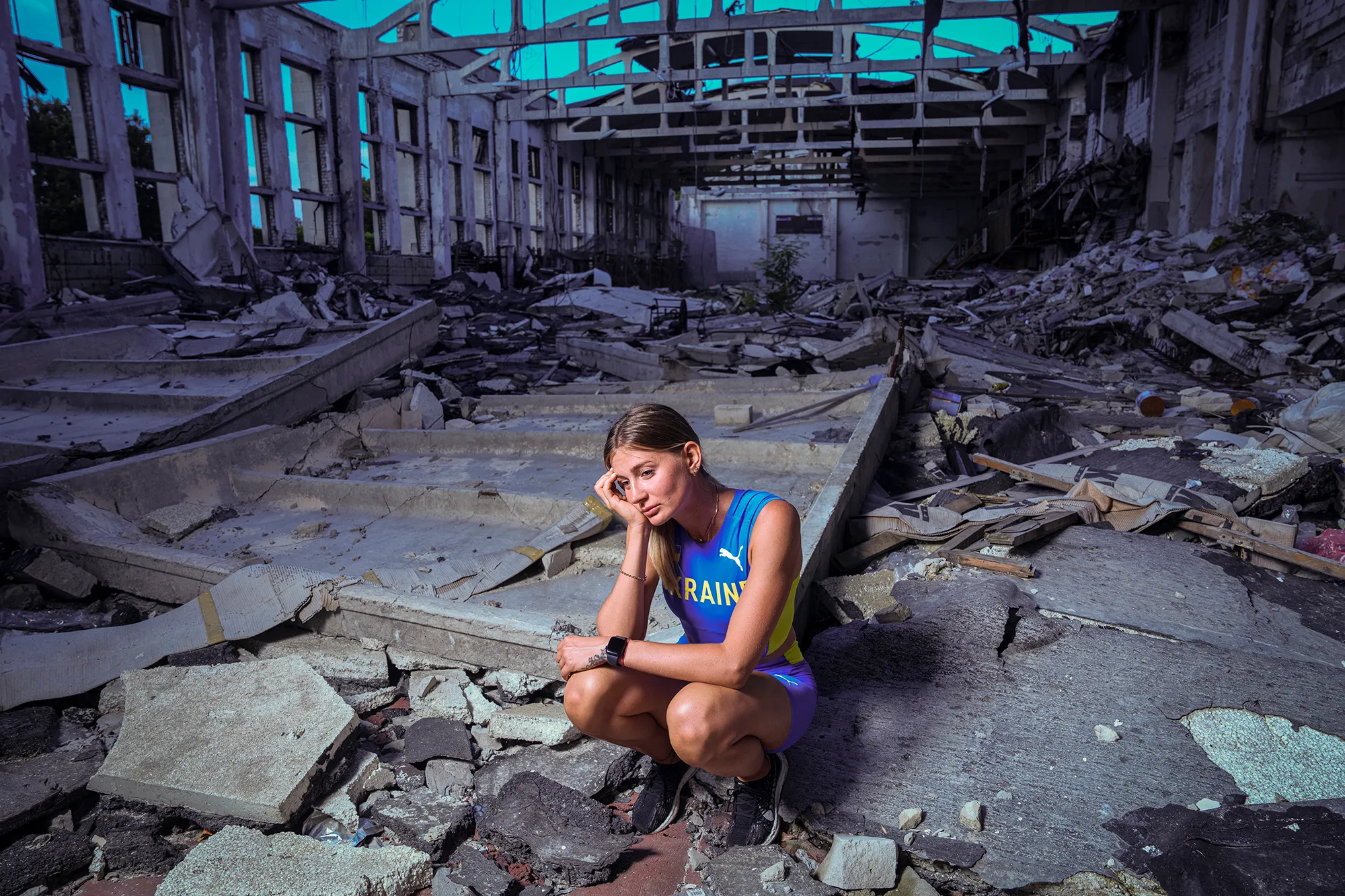 Kateryna Tabashnyk sitting in the rubble of a bombed building